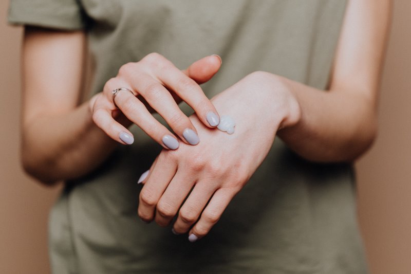 Handcreme auf Händen verteilen